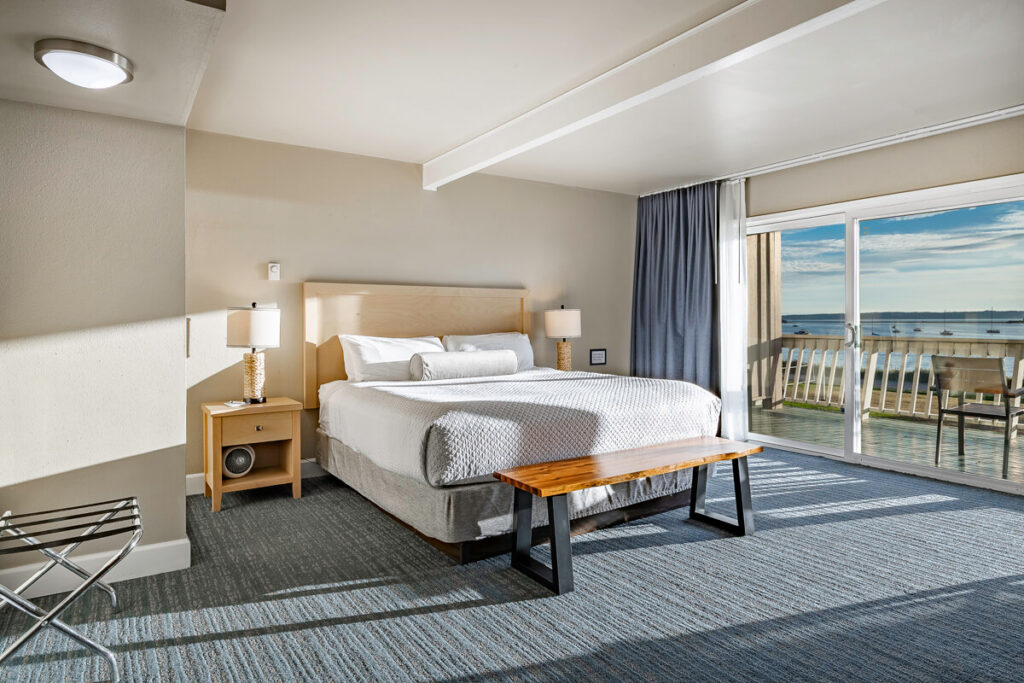 Close-up of the plush king-sized bed and premium linens in the Orca Deluxe.