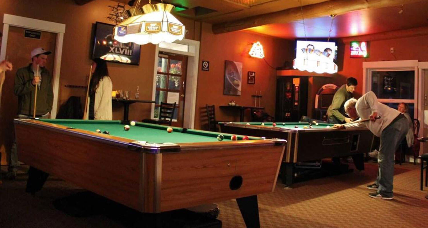 Playing a round of pool Lopez Islander Resort. Locals enjoying a game of pool at the Islander Bar & Grill during the off-season.